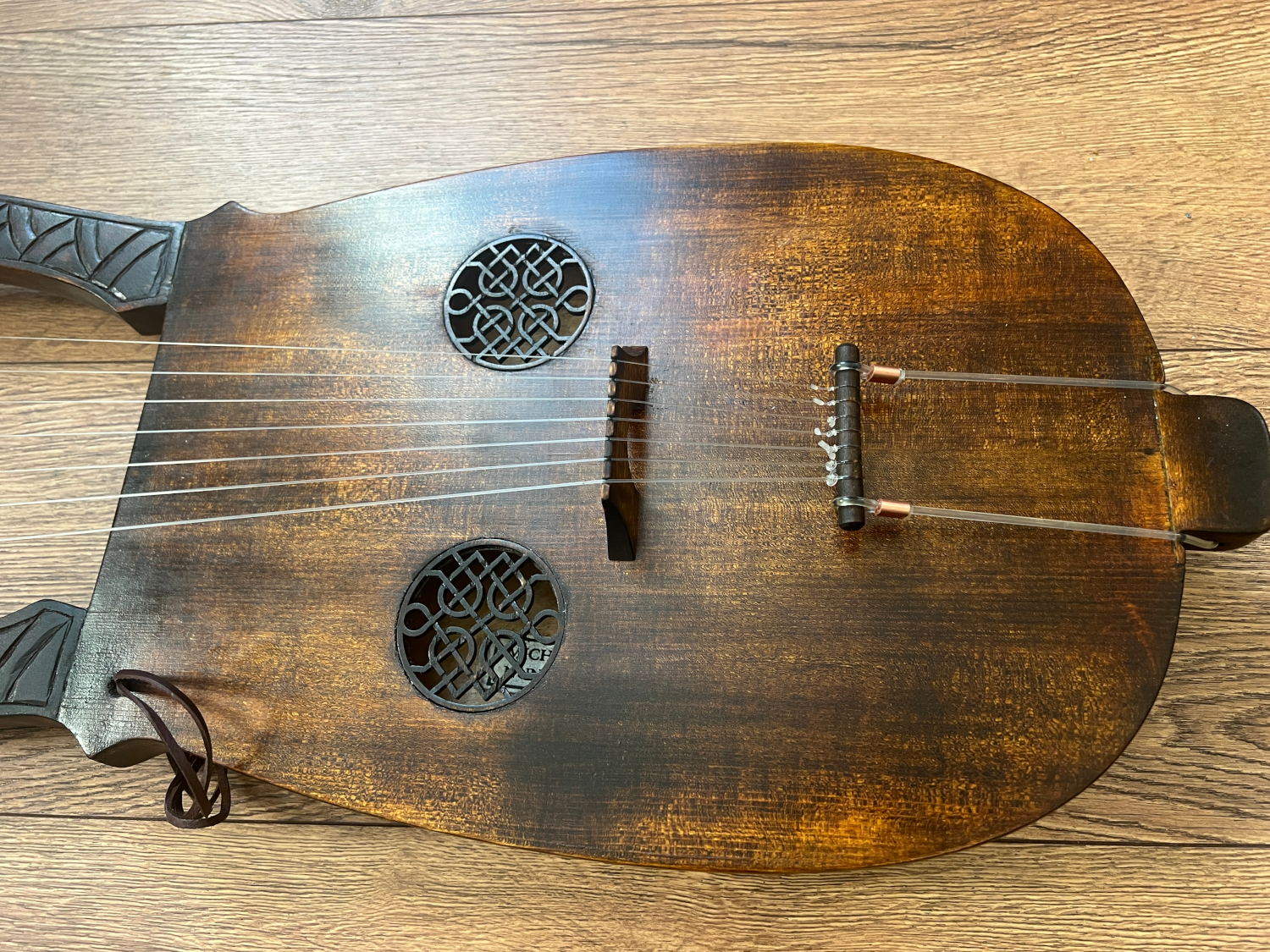 close up-Kravik lyre soundboard with two celtic/viking soundholes